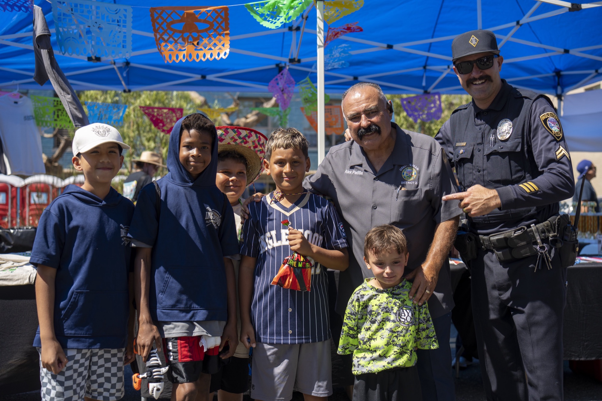 Councilman Alex Padilla with young residents and an Inglewood police officer